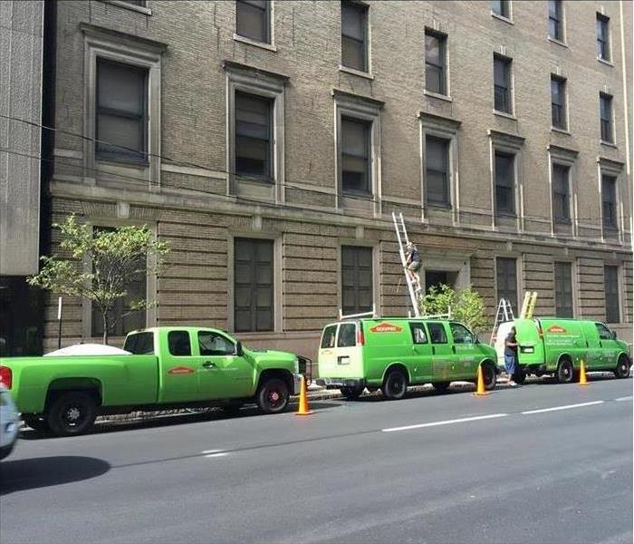 Green SERVPRO vans in front of commercial building 