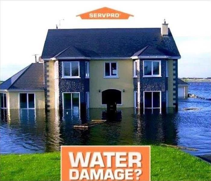 Home surrounded by water with SERVPRO logo and "water damage" text 