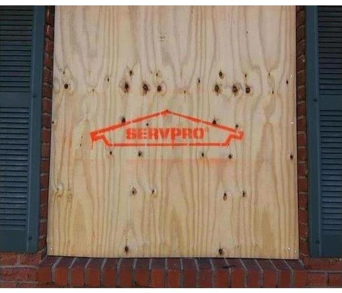 Boarded up window with SERVPRO logo